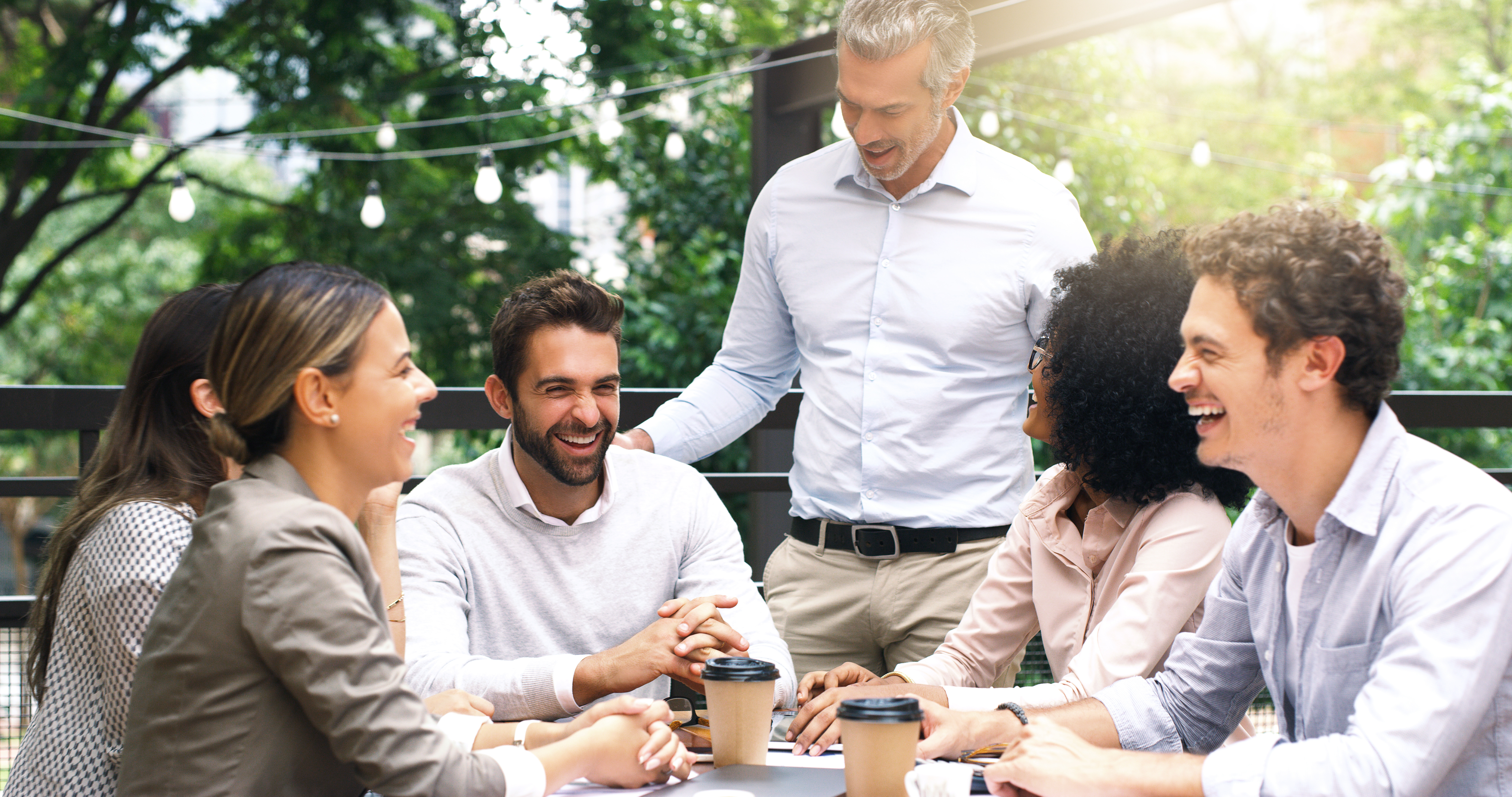 Shot of a group of colleagues having a meeting at a cafe.