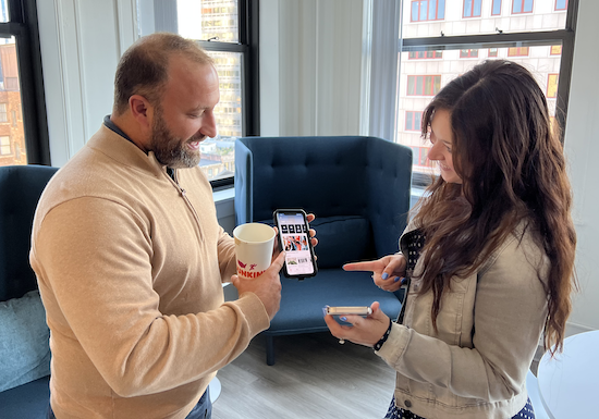 HqO Employees looking at the workplace experience app