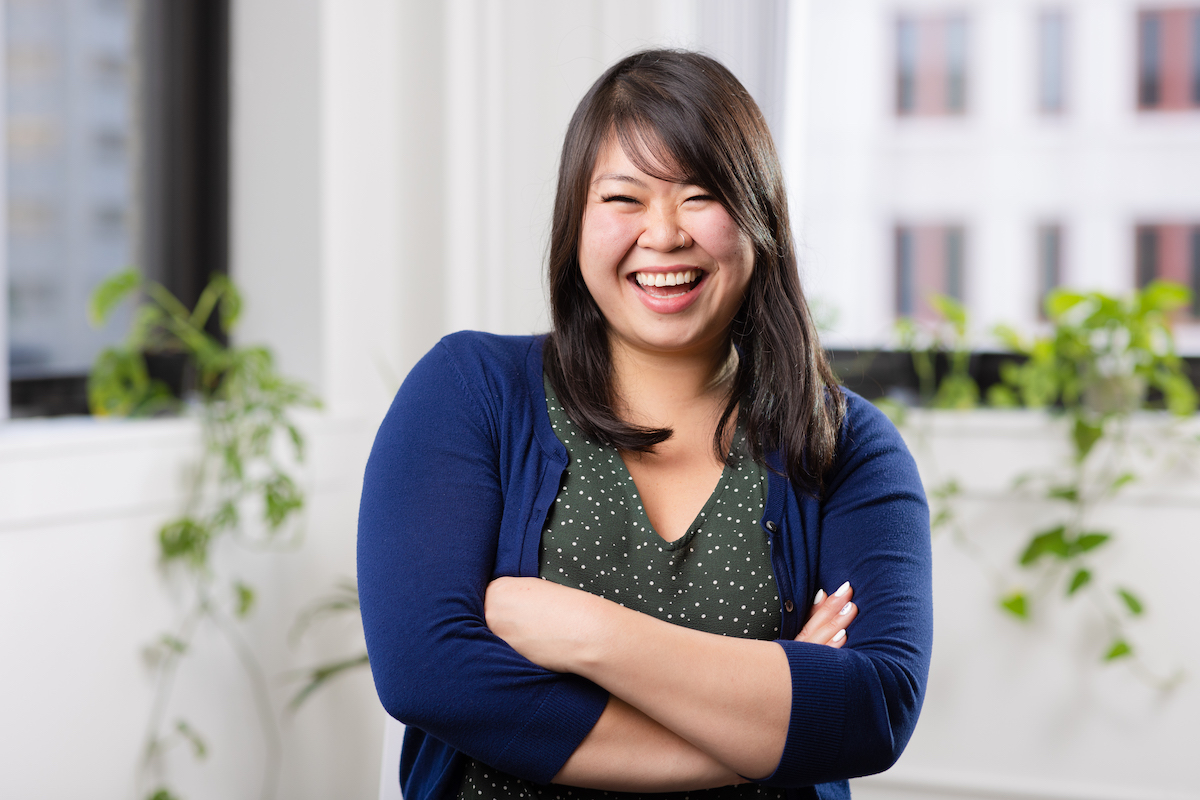 Headshot of HqO Employee smiling in office