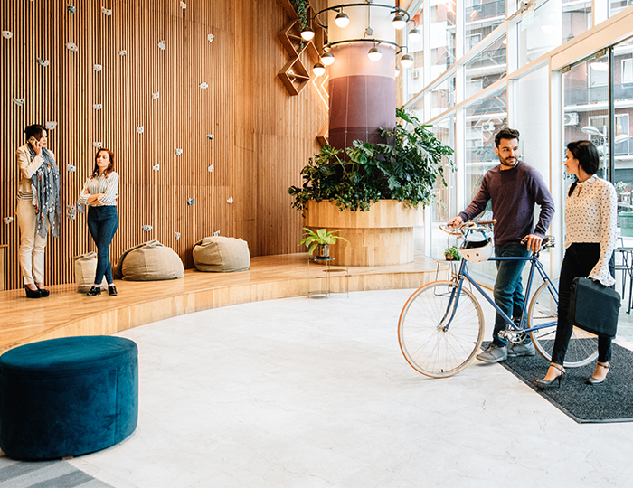 Commuter with bike entering the office