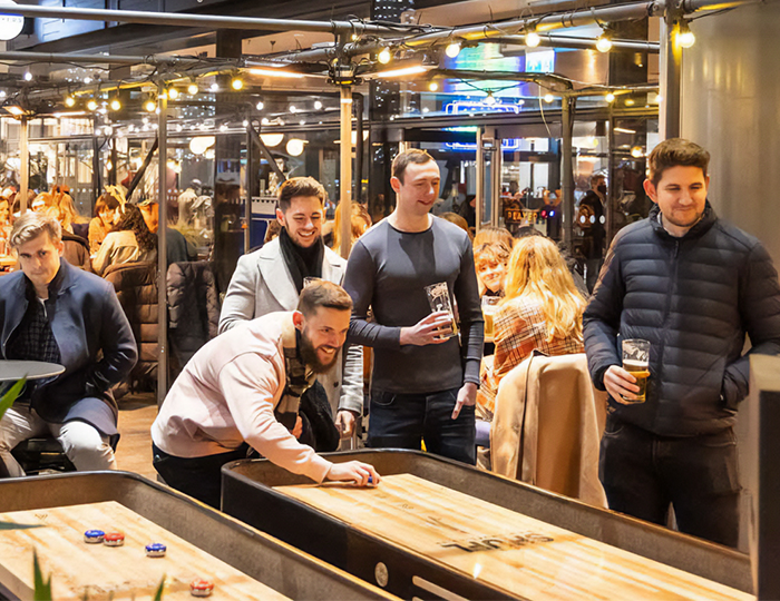 Workers play shuffleboard