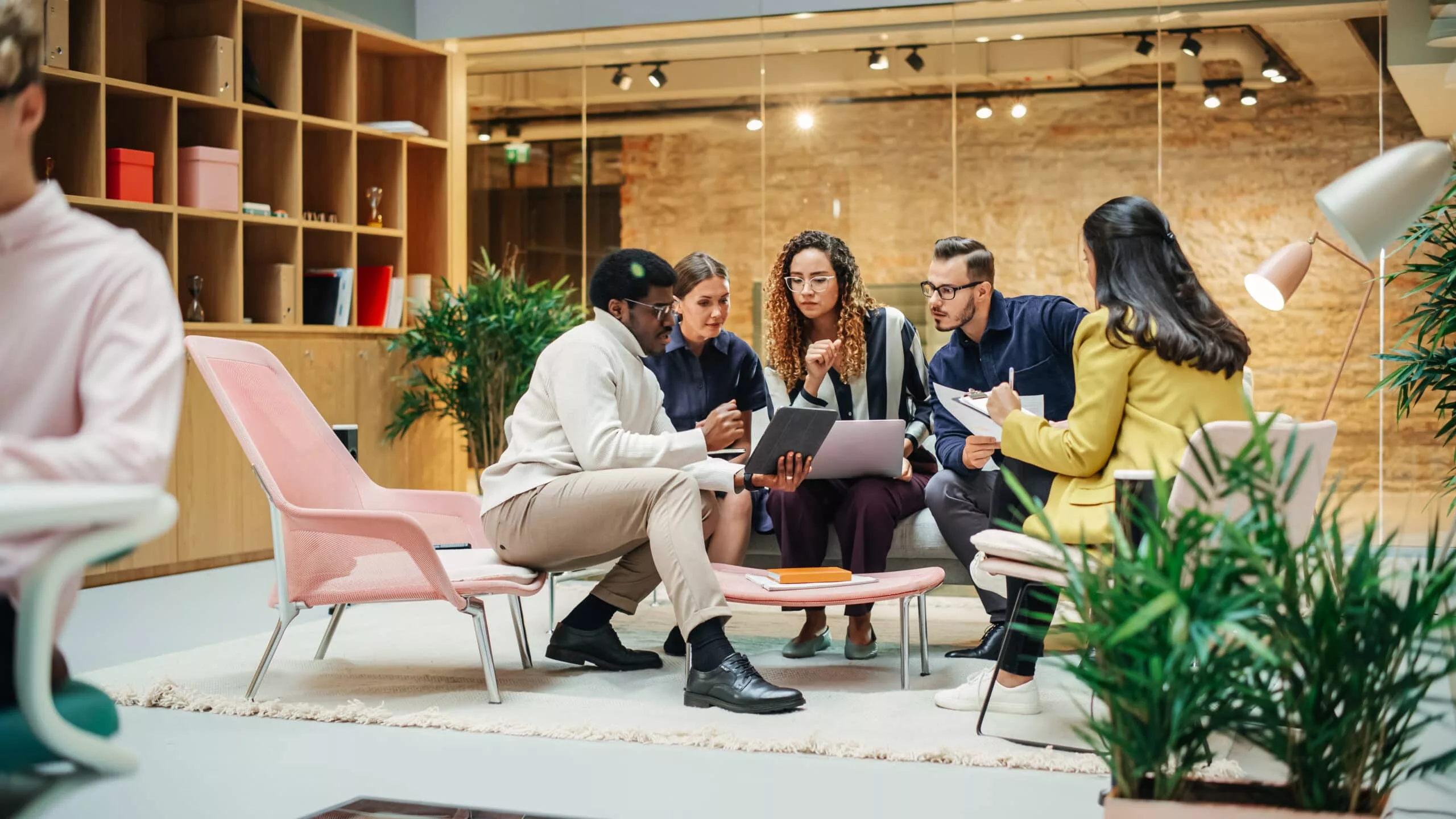 Multiethnic Young Group of People Brainstorming Together in a Me