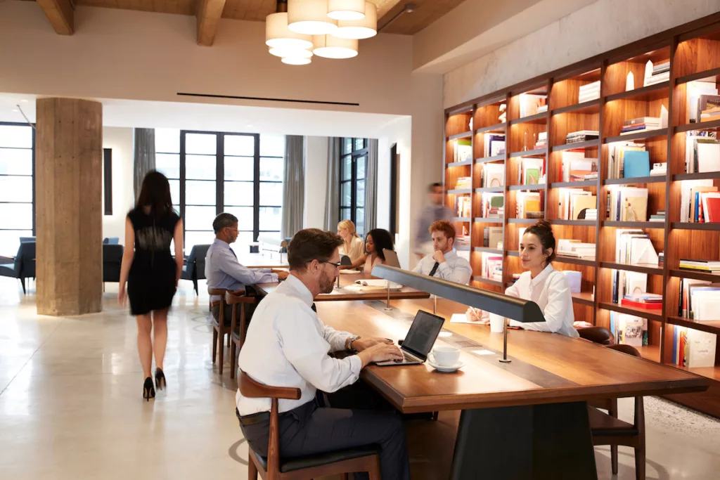 Colleagues working at desks in a busy open plan office area