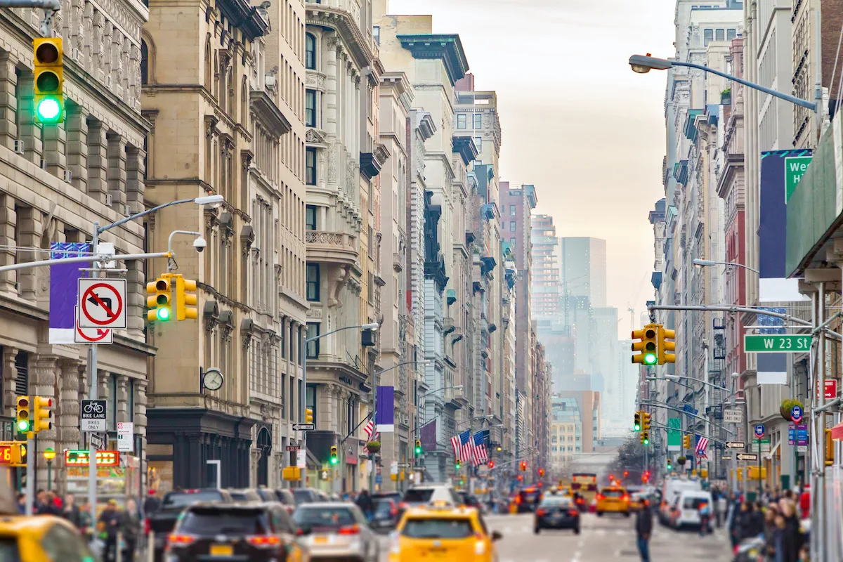 View down Broadway in New York City with people and cars lining the street through Midtown Manhattan