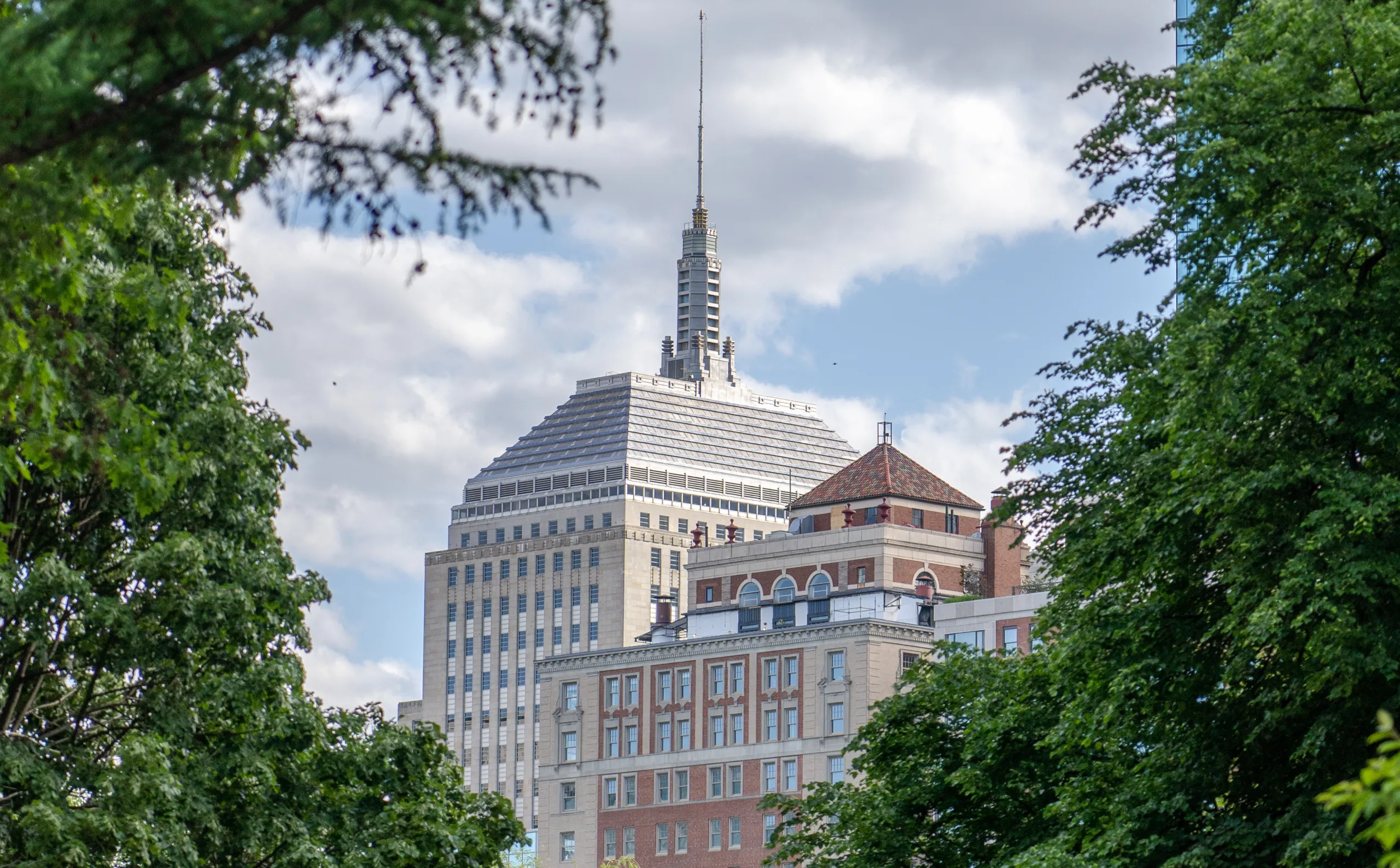 Distant view of Boston skyline from Boston Public Garden during summer time.