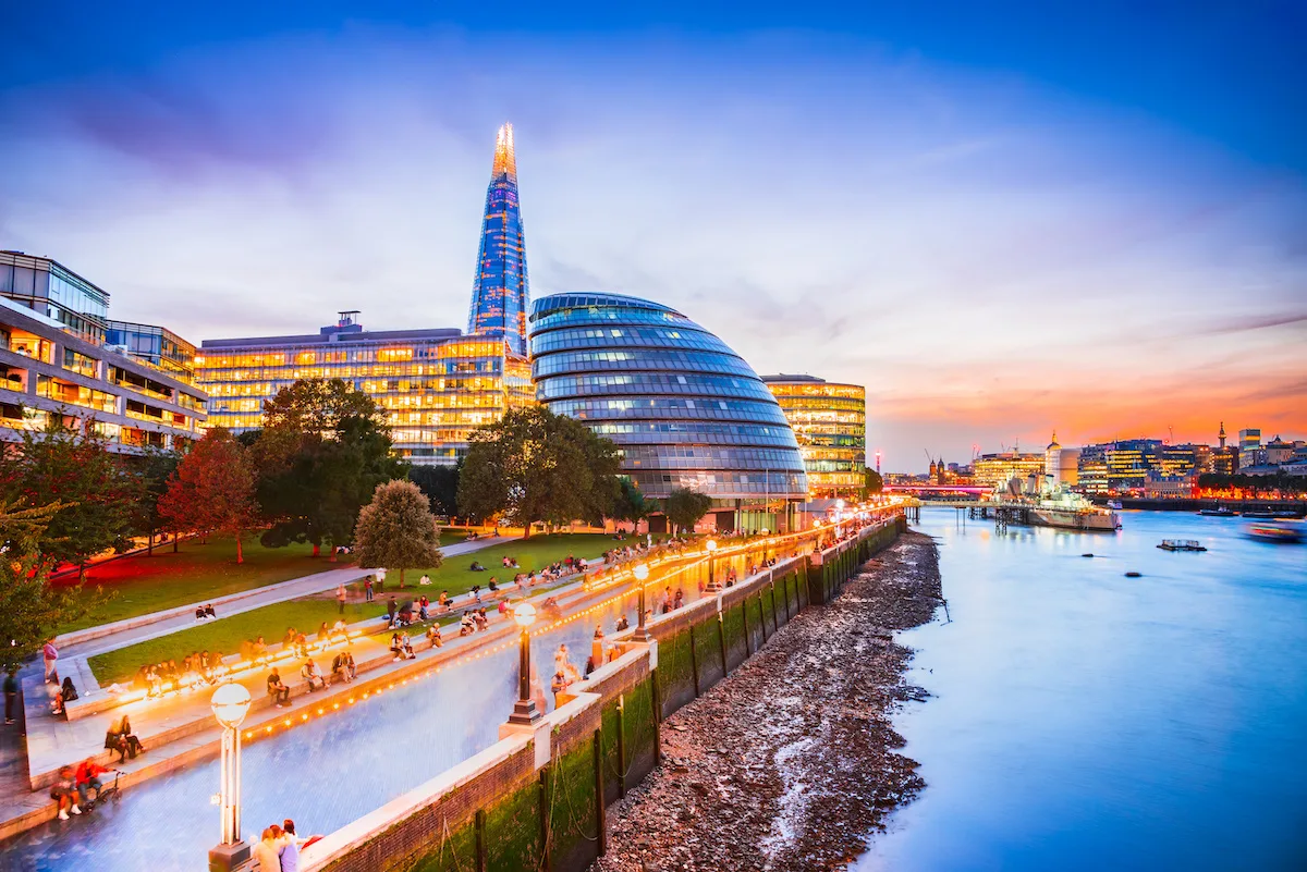 London, United Kingdom. Skyline view  New London, City Hall and Shard, golden sunset hour. View includes Thames River, skyscrapers, office buildings and beautiful sky.